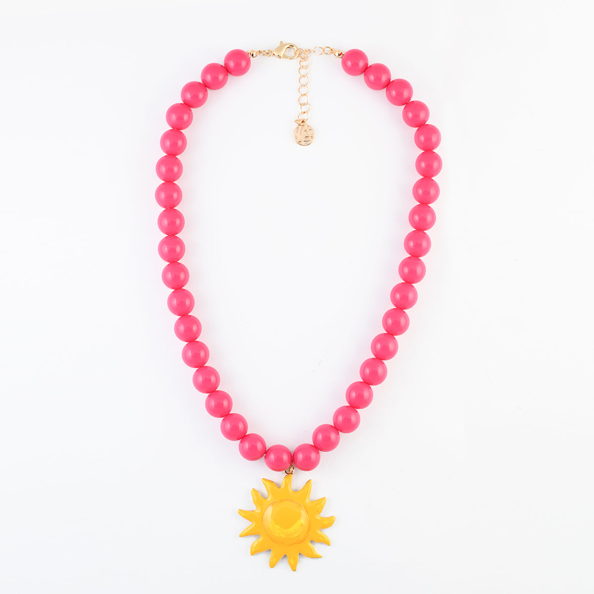 Collier de perles rose fuchsia pendentif soleil